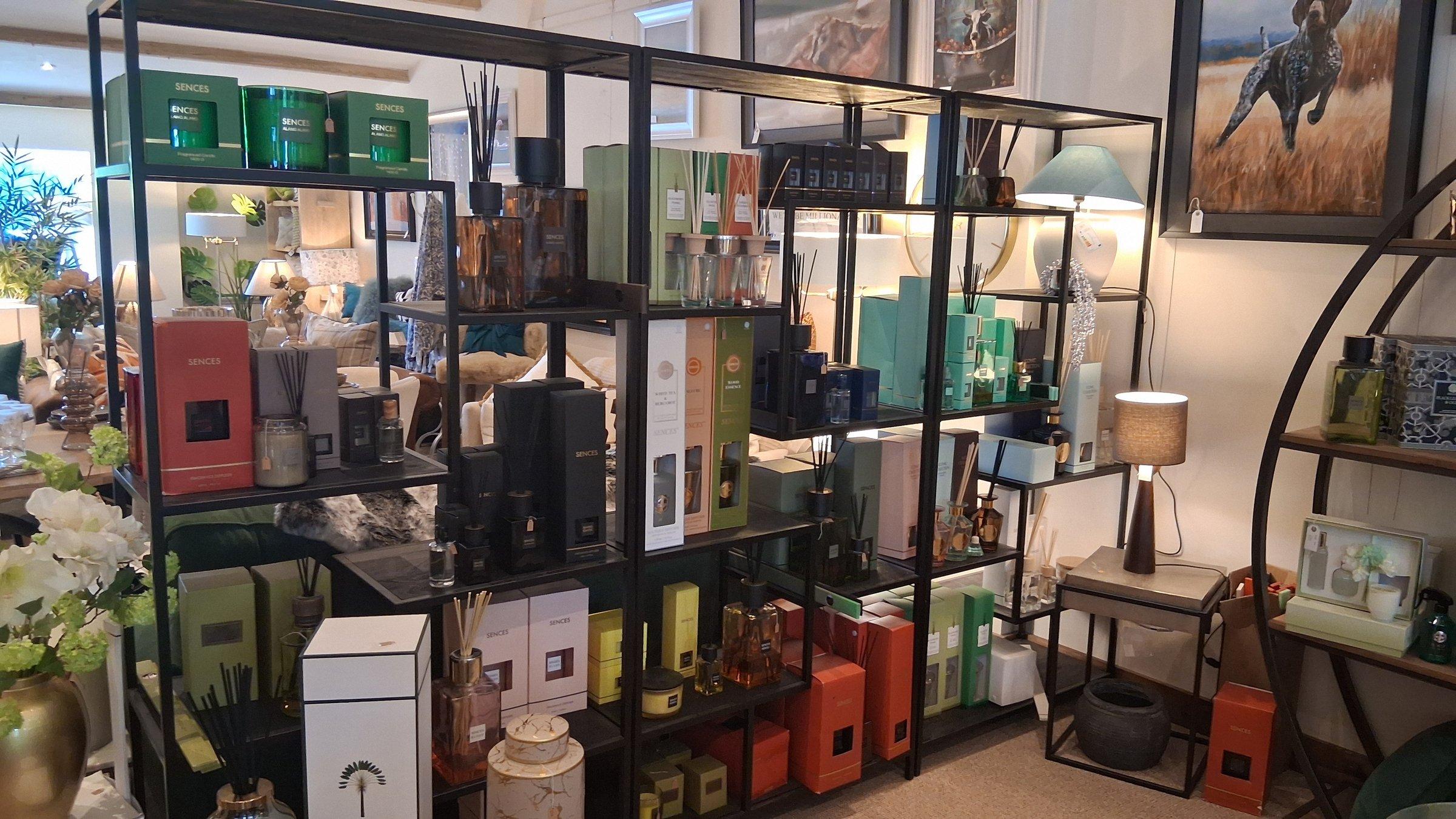 Sences home fragrance display with diffusers and candles in the accessories area