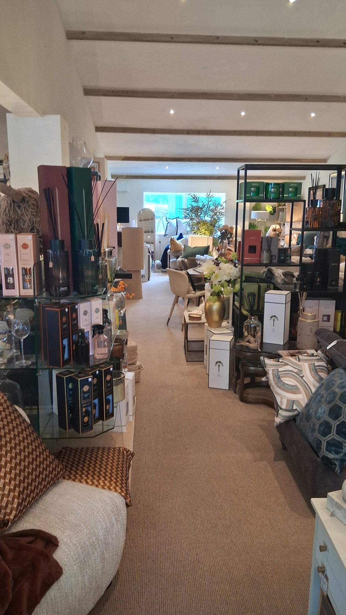 Looking down the aisle of the Canwell showroom past the fragrance shelves towards the seating at the far end